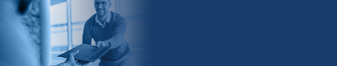 Image of a man handing a paper document to another man.