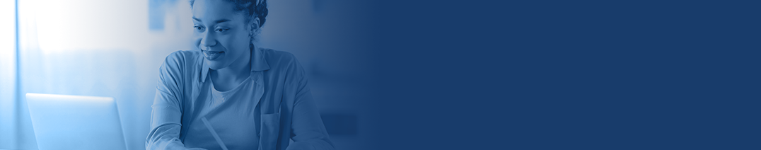 An image of a woman looking downwards at a laptop screen.