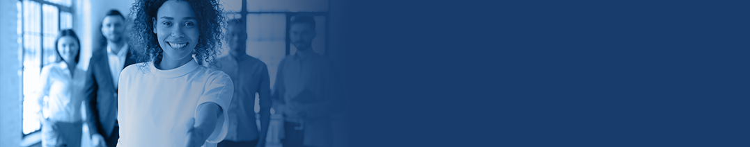 Image of a smiling woman with her arm outstretched to shake a hand, with several people stood behind her.