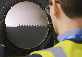 Image of an engineer looking at a magnified image of a fastener